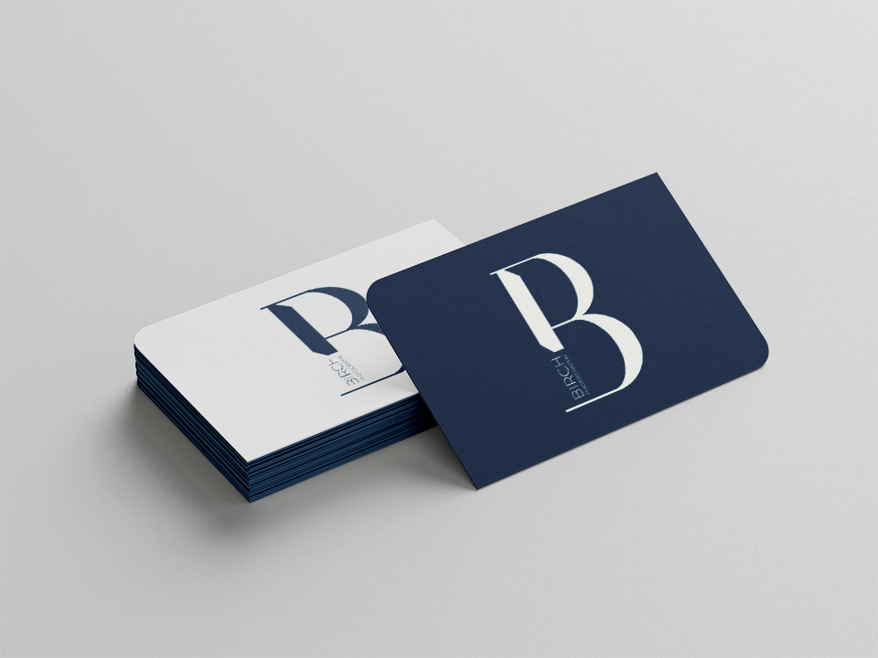 a pile of blue and white business cards displaying the Birch Photography logo.