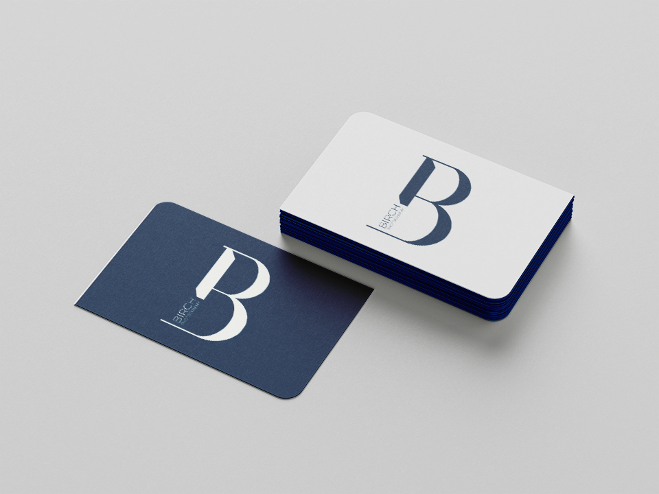 a pile of blue and white business cards displaying the Birch Photography logo.
