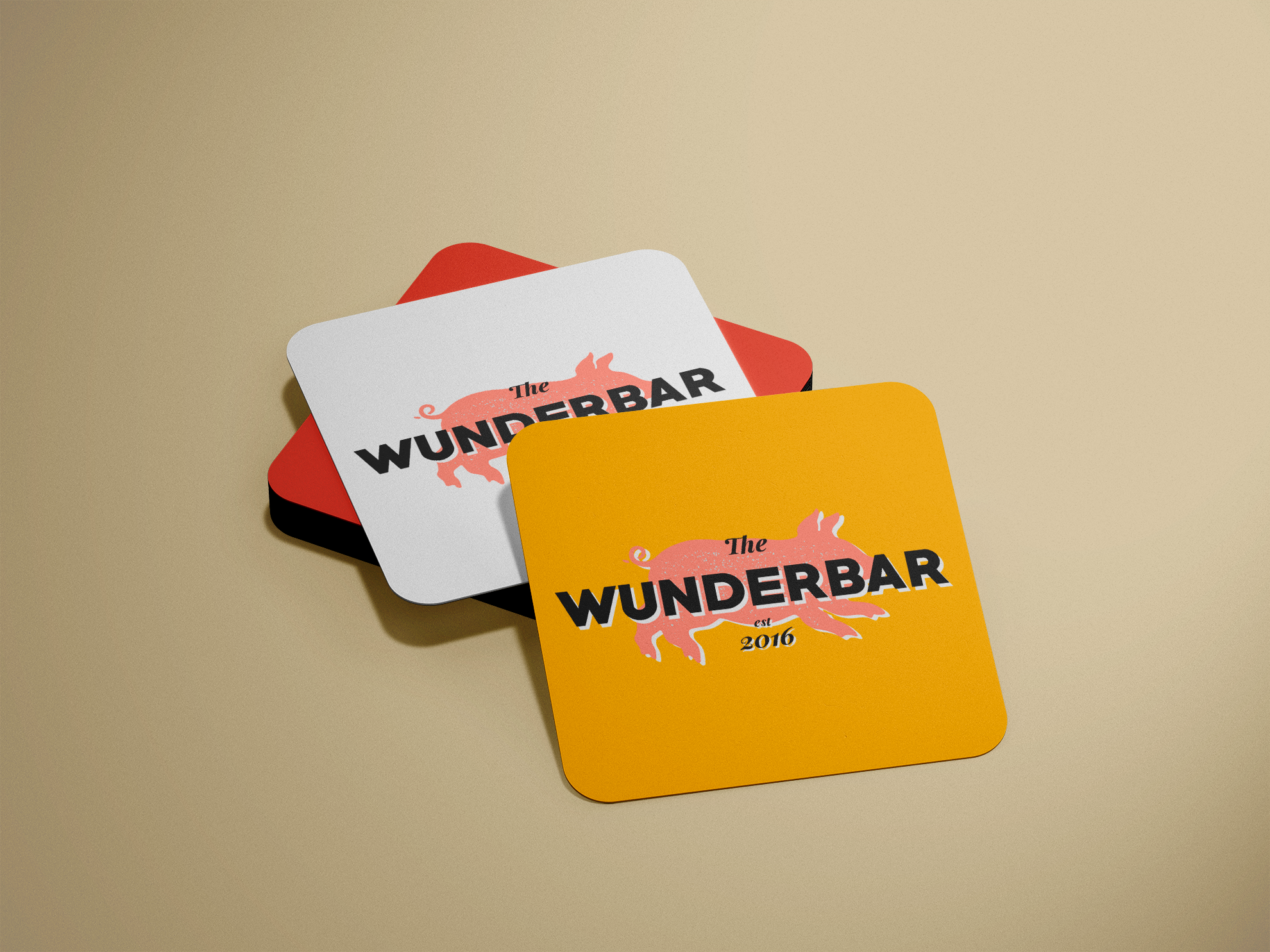 A stack of red, white and yellow beer coasters displaying the Wunderbar logo.